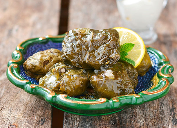 Dolmades oder Dolmadakia: Weinblätter, die typischerweise mit Reis, Gewürzen, Rosinen und Zwiebeln gefüllt und als Vorspeise angeboten werden.