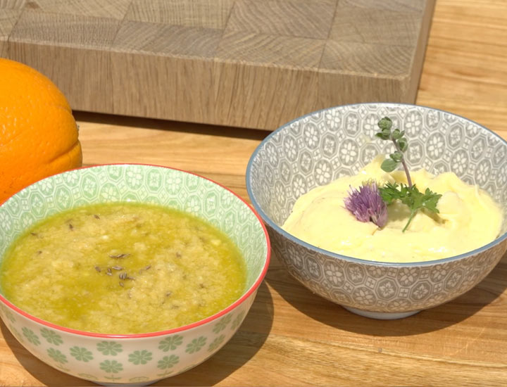 Schüsseln mit Knoblauchbutter und Hummus