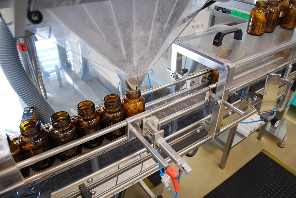 Gut dosiert: Genau die richtige Menge Tabletten fällt aus dem Trichter in den Glasbehälter. (Foto: A.Vogel AG) Tabletten-Abfüllung